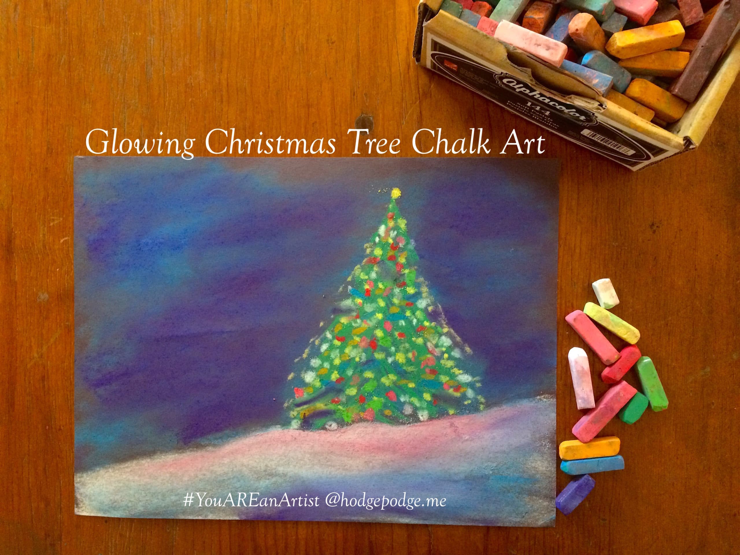 Enjoy a glowing Christmas tree chalk art tutorial and make a dreamy Christmas scene with your artists. The perfect art project to celebrate the season.